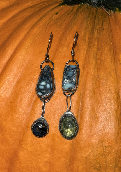 Pair of earrings with gemstones on a pumpkin background